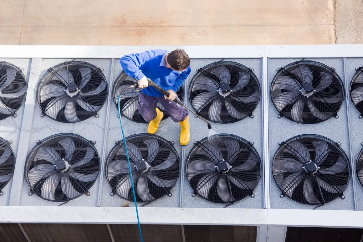 HVAC technician installing a ceiling vent in a home